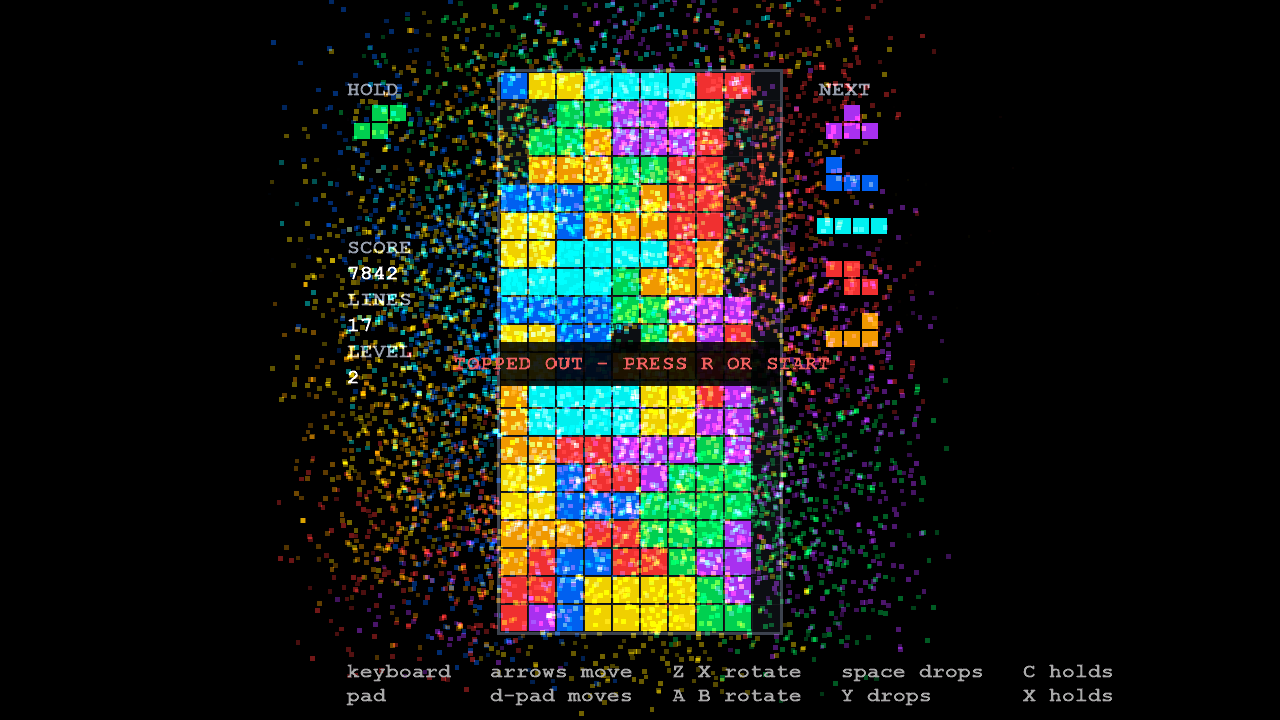 LineSweeper at the end of a game: a full well, the banner 'TOPPED OUT - PRESS R OR START', and thousands of coloured sparks thrown out across the screen.